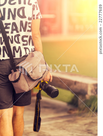 Close up of man holding a camera Close up of man holding a camera 22777689