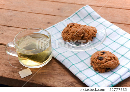 Cup glass of green tea and cookies 22777883