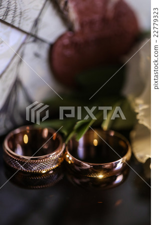 wedding rings on the glass table in black and 22779323