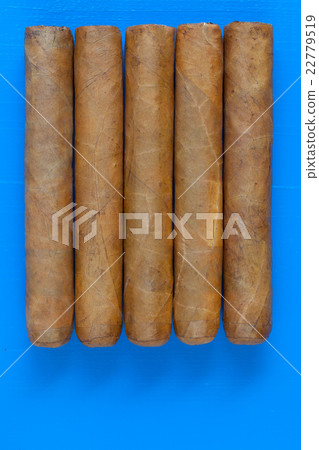 Detail of luxury Cuban cigars on the blue desk 22779519