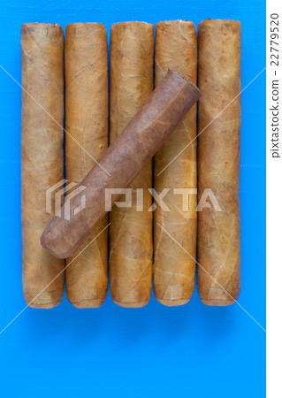 Detail of luxury Cuban cigars on the blue desk 22779520