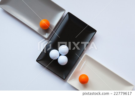 Different ceramic dishes with golf balls Different ceramic dishes with golf balls 22779617