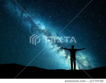 Night landscape. Milky Way and silhouette of a man Night landscape. Milky Way and silhouette of a man 22779780