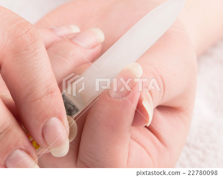 Woman making manicure herself, using nailfile 22780098