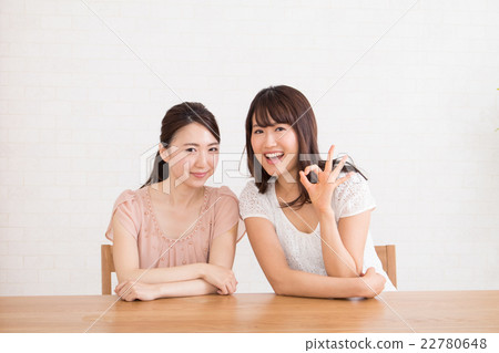 A smiley woman giving an OK sign 22780648