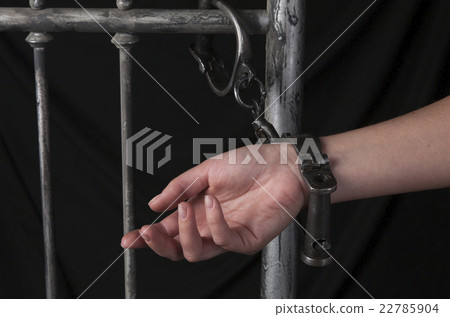female hand chained to the bed on black background 22785904