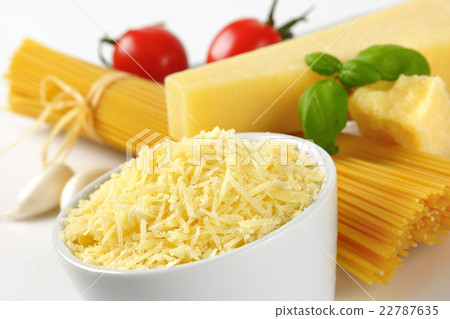 parmesan cheese and uncooked spaghetti parmesan cheese and uncooked spaghetti 22787635