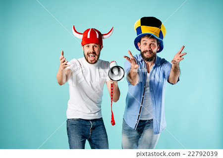 The two football fans with mouthpiece over blue 22792039