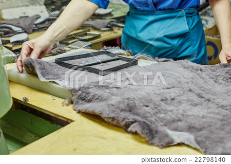 Image of worker puts templet on pelt Image of worker puts templet on pelt 22798140