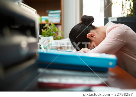 Tired businesswoman sleeping on the desk. Tired businesswoman sleeping on the desk. 22798287