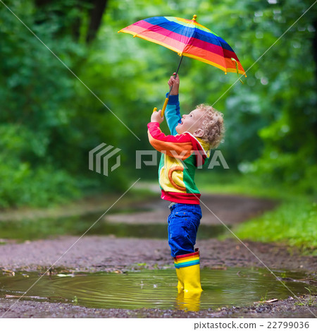 Child playing in the rain 22799036