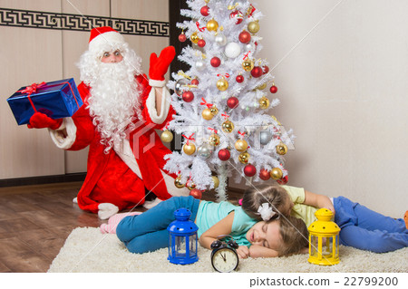 Santa Claus in New Years Eve was surprised seeing the tree two sleeping children Santa Claus in New Years Eve was surprised seeing the tree two sleeping children 22799200