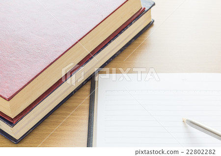 Pen writing on Notebook open blank page 22802282