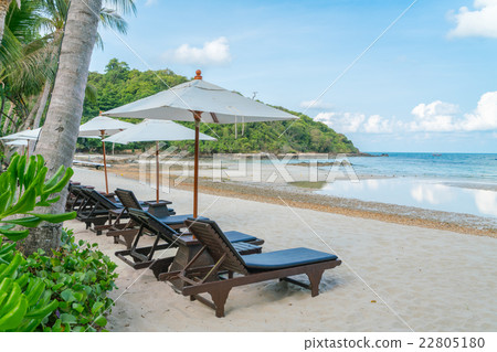 Beautiful beach chairs with umbrella on tropical white sand beach 22805180