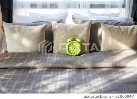 modern bedroom with green alarm clock on bed modern bedroom with green alarm clock on bed 22806047