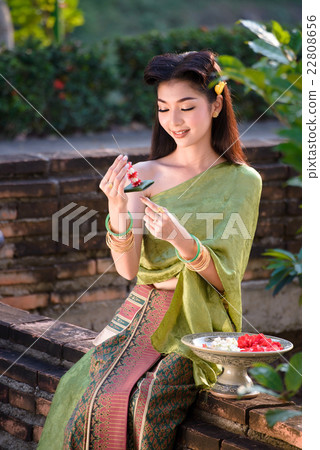 Beautiful woman wearing in Thai traditional costume ,woman sitti Beautiful woman wearing in Thai traditional costume ,woman sitti 22808656