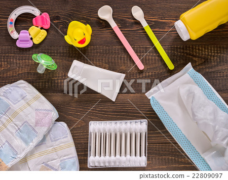 Baby essentials and care on dark wooden table 22809097