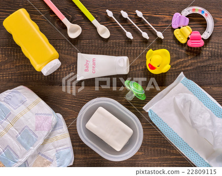 Baby essentials and care on dark wooden table Baby essentials and care on dark wooden table 22809115
