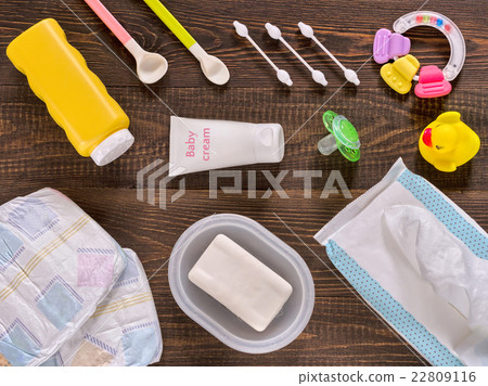 Baby essentials and care on dark wooden table Baby essentials and care on dark wooden table 22809116