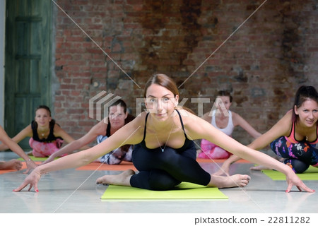 Group young women stretching and practices yoga 22811282