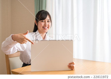 Female high school student who points to message board Female high school student who points to message board 22811972