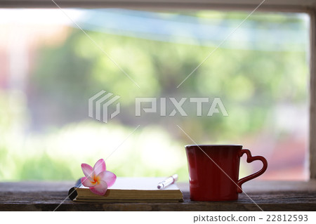 Red mug and notebooks with flower 22812593