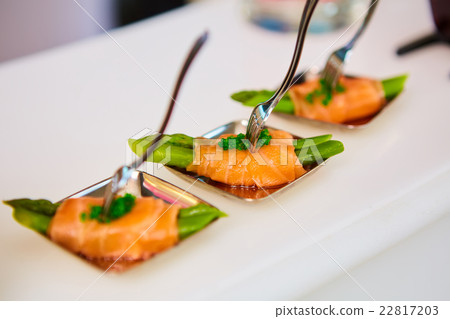 Appetizer plate of sauteed asparagus wrapped in 22817203