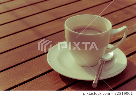 hot coffee and sunshine on wooden background hot coffee and sunshine on wooden background 22819061