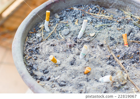 Smoked Cigarettes Butts in a Public Ashtray 22819067