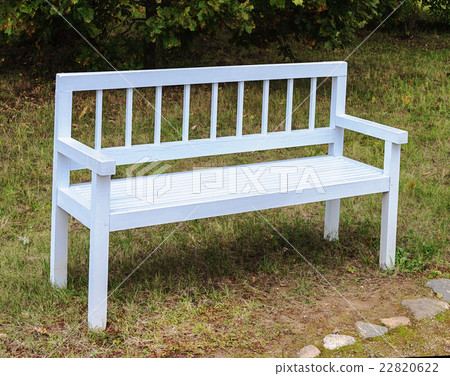 White wooden bench in park White wooden bench in park 22820622