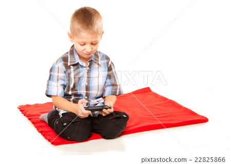 Little boy playing games on smartphone Little boy playing games on smartphone 22825866