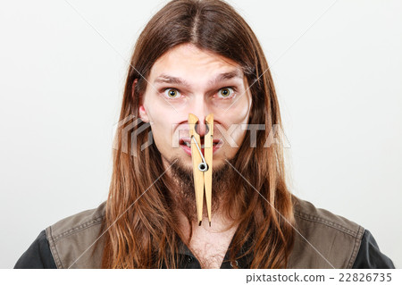 Man with clogged nose by clothespin Man with clogged nose by clothespin 22826735