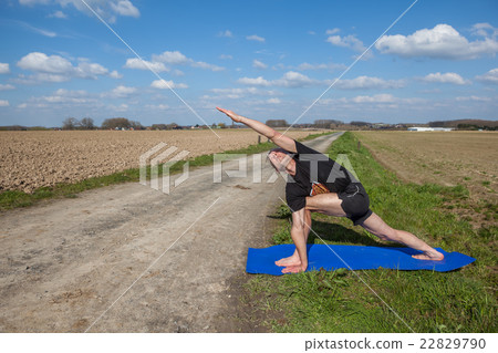 Enjoy Utthita Parsvakonasana yoga in Nature 22829790