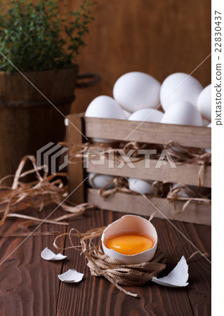 White eggs on brown wooden background 22830437