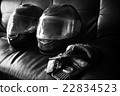 helmet and leather gloves on sofa 22834523