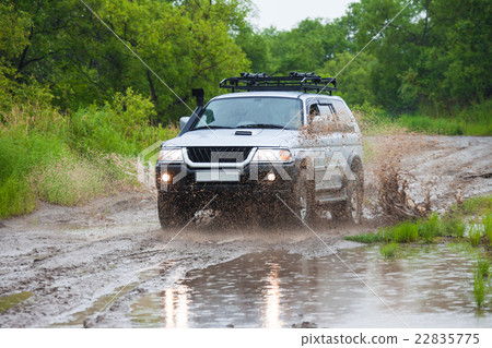 Mitsubishi Pajero moving by water making splashes Mitsubishi Pajero moving by water making splashes 22835775