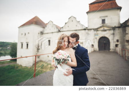 Happy wedding couple hugging and smiling each Happy wedding couple hugging and smiling each 22836869