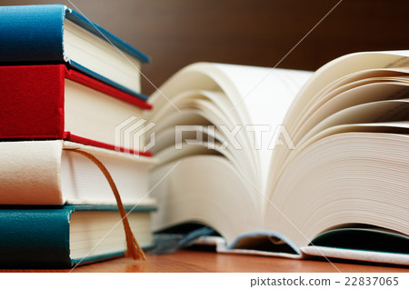 A stacked book and a big book opened 22837065