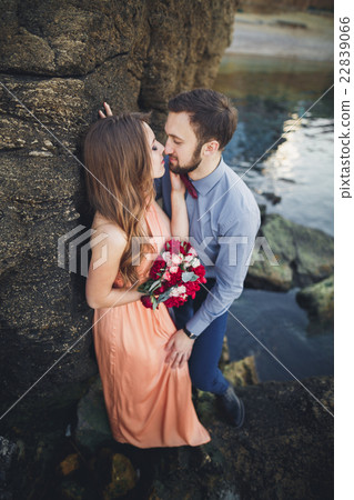Wedding couple kissing and hugging on rocks near Wedding couple kissing and hugging on rocks near 22839066