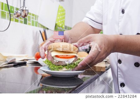 Chef cooking and decorated Hamburger Chef cooking and decorated Hamburger 22843284