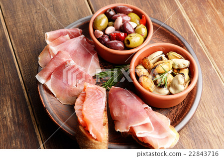 Tapas of salmon, mussels, jamon and olives Tapas of salmon, mussels, jamon and olives 22843716