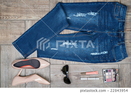 Aerial  view of woman's jeans and accessories 22843954