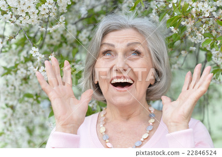 Older woman with  flowers 22846524