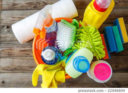 Plastic bucket with cleaning supplies on wood 22846604