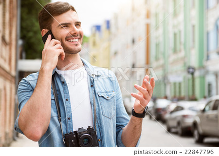 Cheerful man talking on cell phone. 22847796
