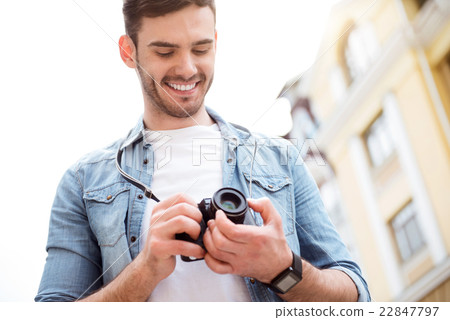 Pleasant smiling man standing in the street 22847797