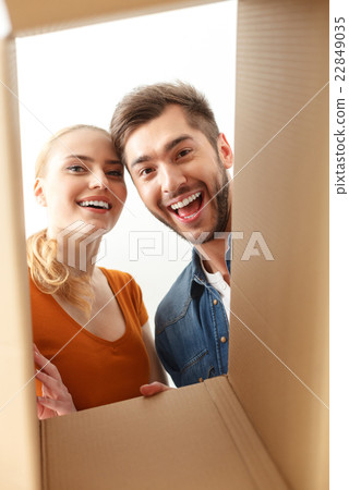 Happy couple looking inside of box Happy couple looking inside of box 22849035