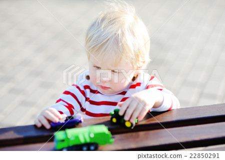 Toddler boy playing with toy cars Toddler boy playing with toy cars 22850291