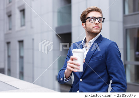 Cheerful male worker is resting on balcony 22850379