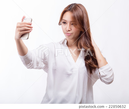 Asian woman with smart phone taking a selfie Asian woman with smart phone taking a selfie 22850632